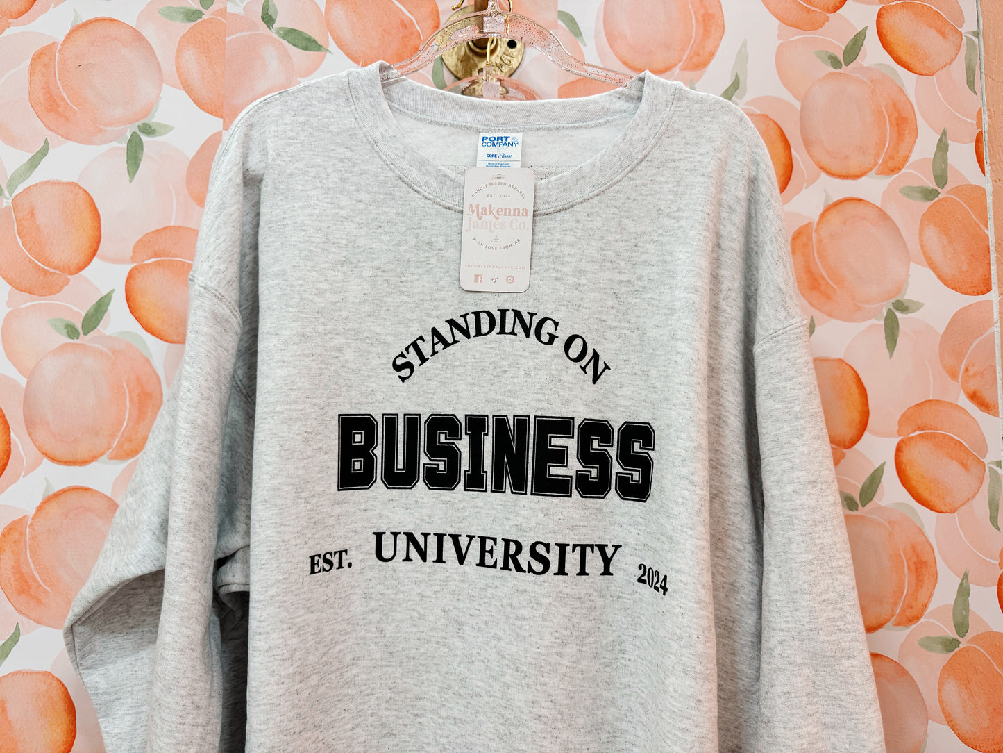 standing on business university sweatshirt